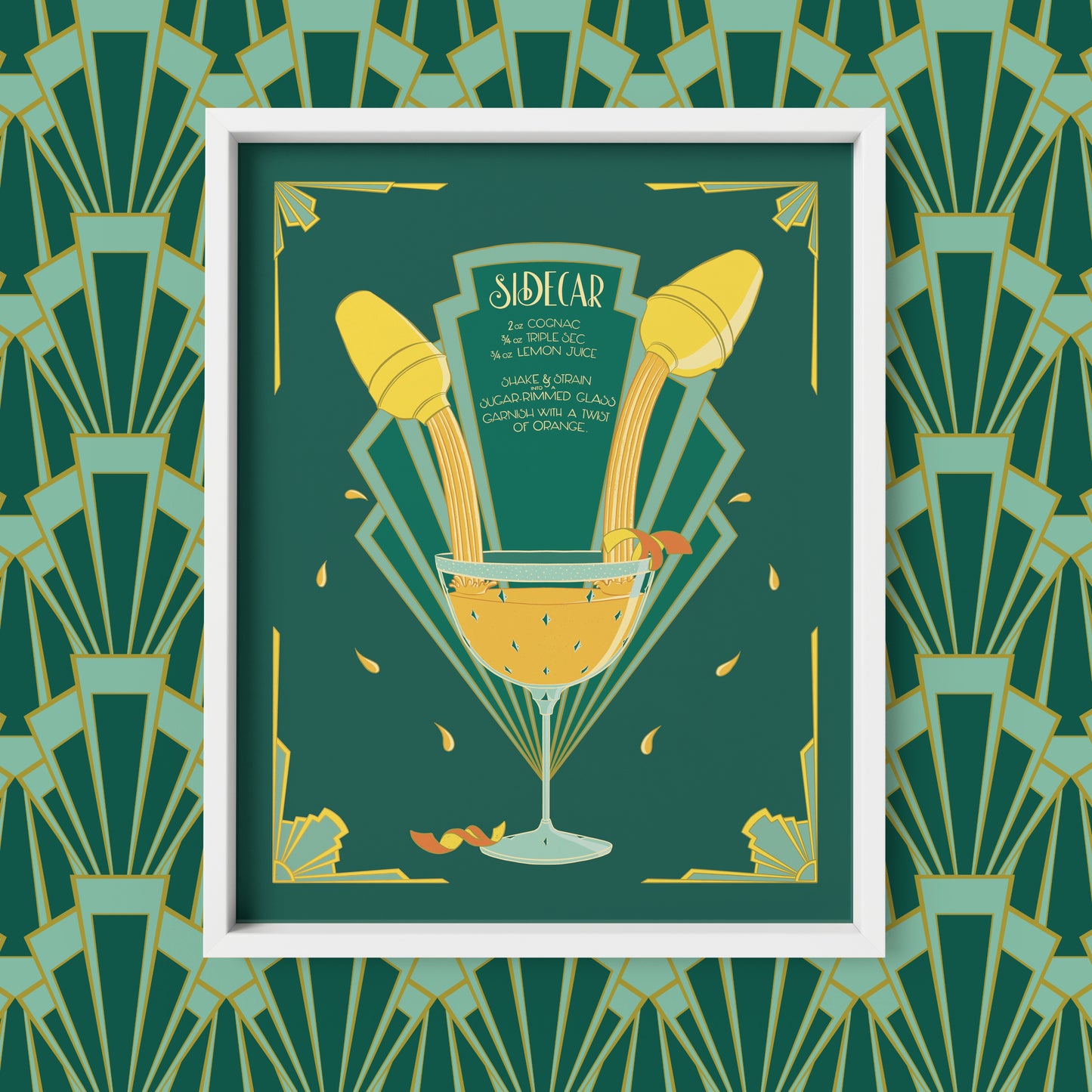 A green and yellow art deco illustration features a hand-lettered recipe for a sidecar as will as images of cocktail shakers and a full glass. The print is shown framed against an art deco patterned background.