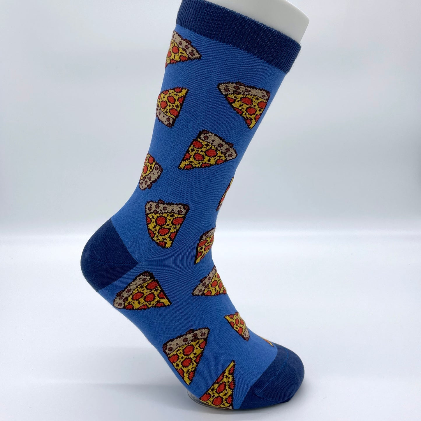 A white sock mannequin sports a blue sock patterned with slices of pepperoni pizza.