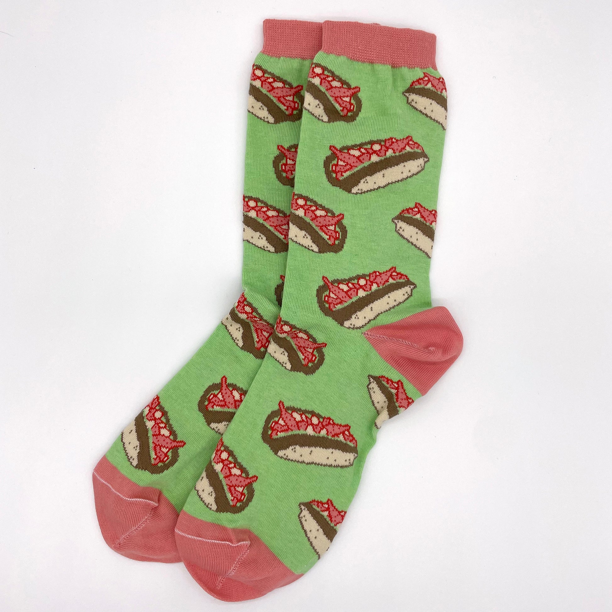 A pair of green socks patterned with lobster rolls lie flat on a white background. The welts, heels and toes of the socks are pink.