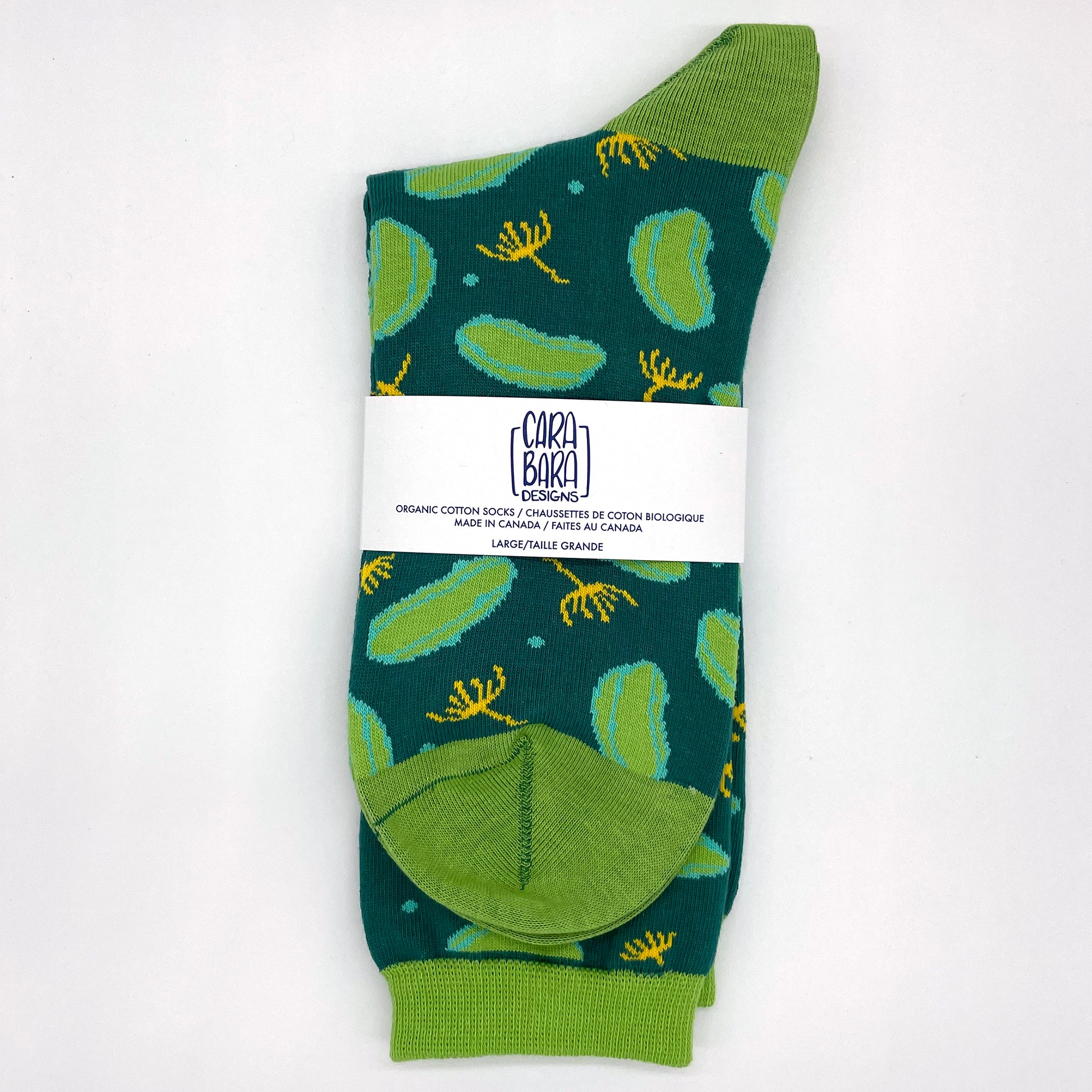 A pair of dill pickle socks is folded and contained by a Carabara Designs belly band.