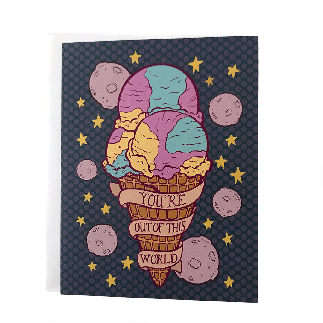 A purple greeting card features a triple scoop waffle cone of Moon Mist ice cream, purple moons, yellow stars and a banner that reads you're out of this world in hand lettering. The card sits against a white envelope on a white background.
