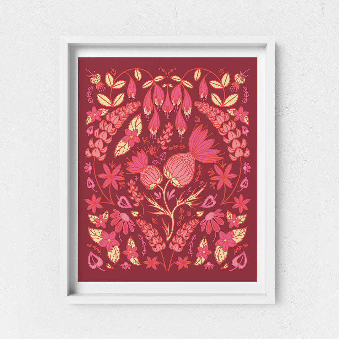 A pink and yellow illustration of thistles and other wildflowers in a full, folk-art style composition. Other flowers include lupies, echinacea, and haskap blossoms. The print is in a white frame on a white background.
