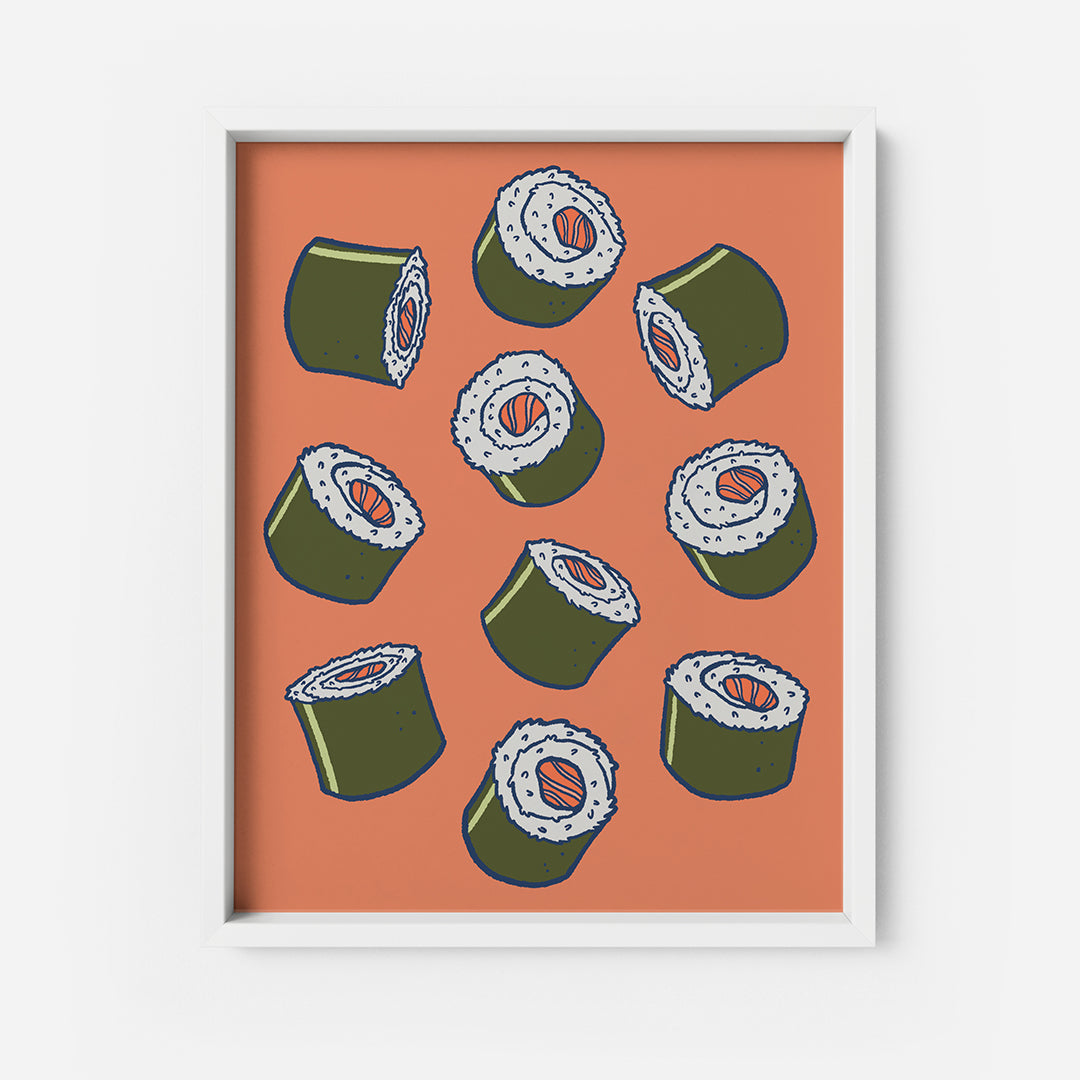 An art print depicts a cluster of seaweed-wrapped sushi rolls with salmon at the centre on an orange background. The print is in a white frame on a white background.