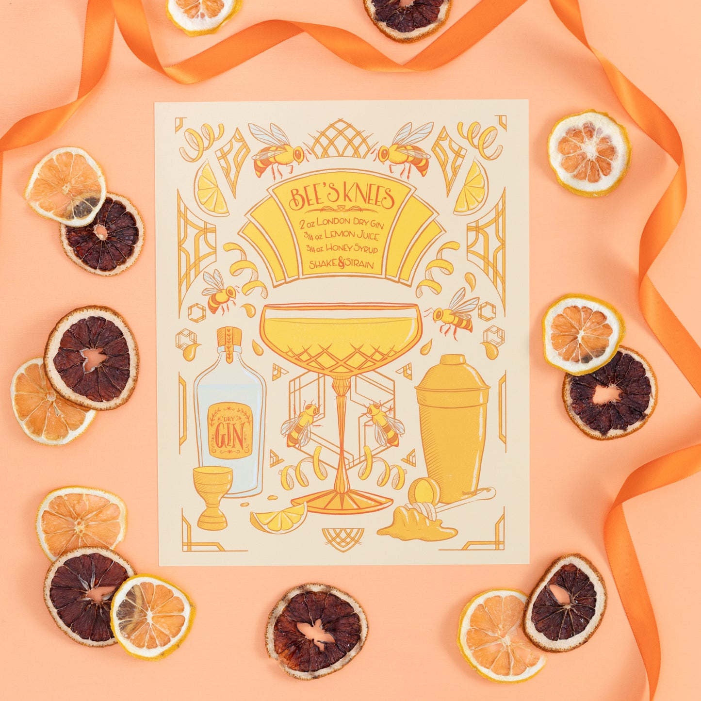 An art deco illustrated art print of a bee's knees cocktail is on orange with citrus slices and ribbon.
