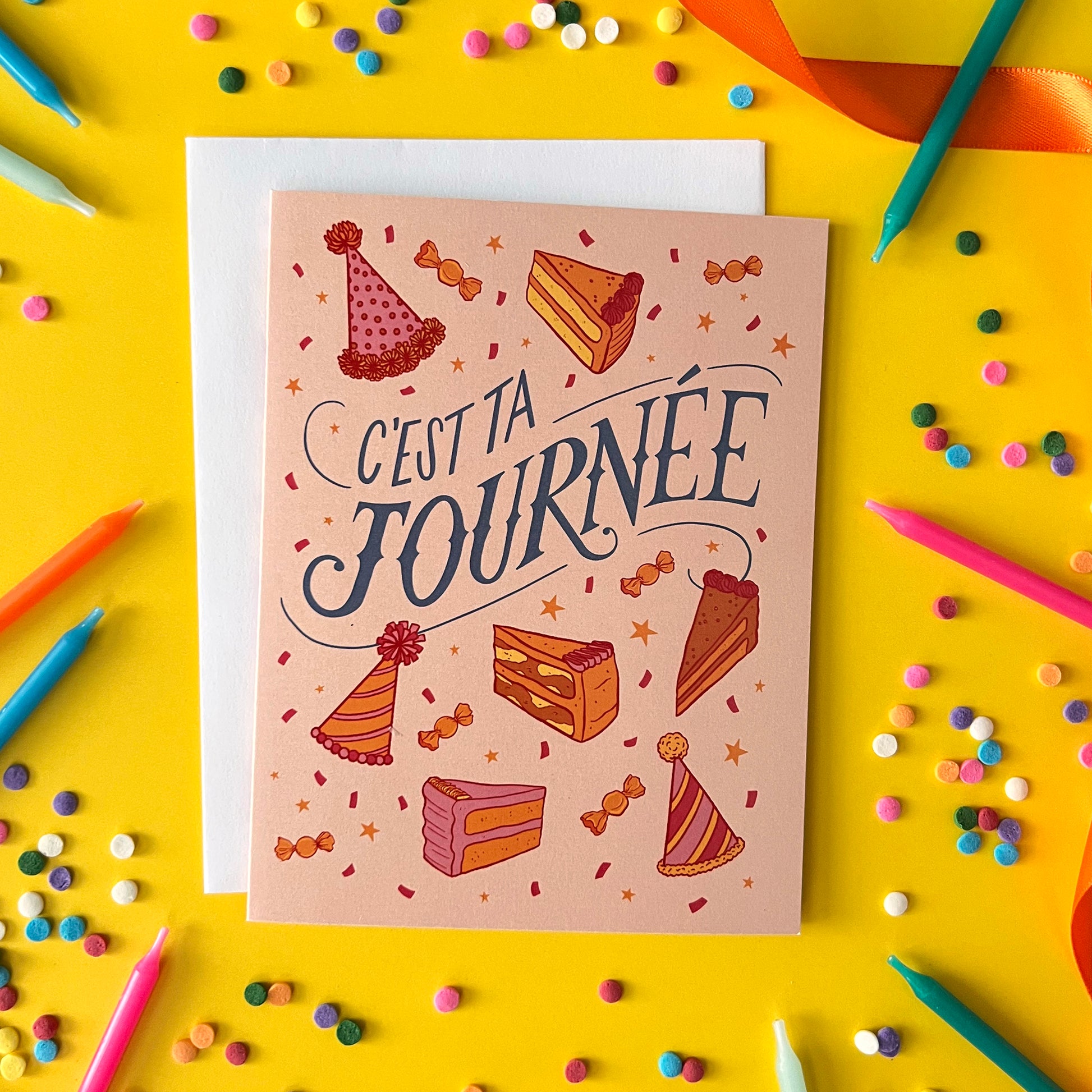 A birthday card reads 'c'est ta journée' among cake slices and party hats. The card is on yellow with candles and confetti.