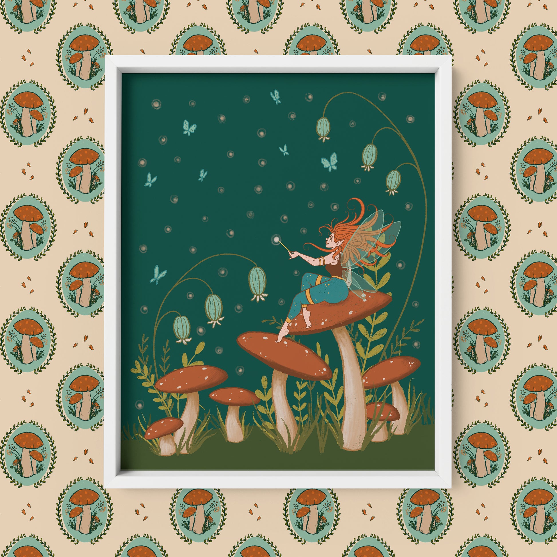 A cottagecore-style illustration shows a winged faerie with turquoise pants sits atop a red-capped mushroom in a field of mushrooms, wildflowers and blue butterflies at night. The print is in a white frame on a patterned background of mushroom cameos.