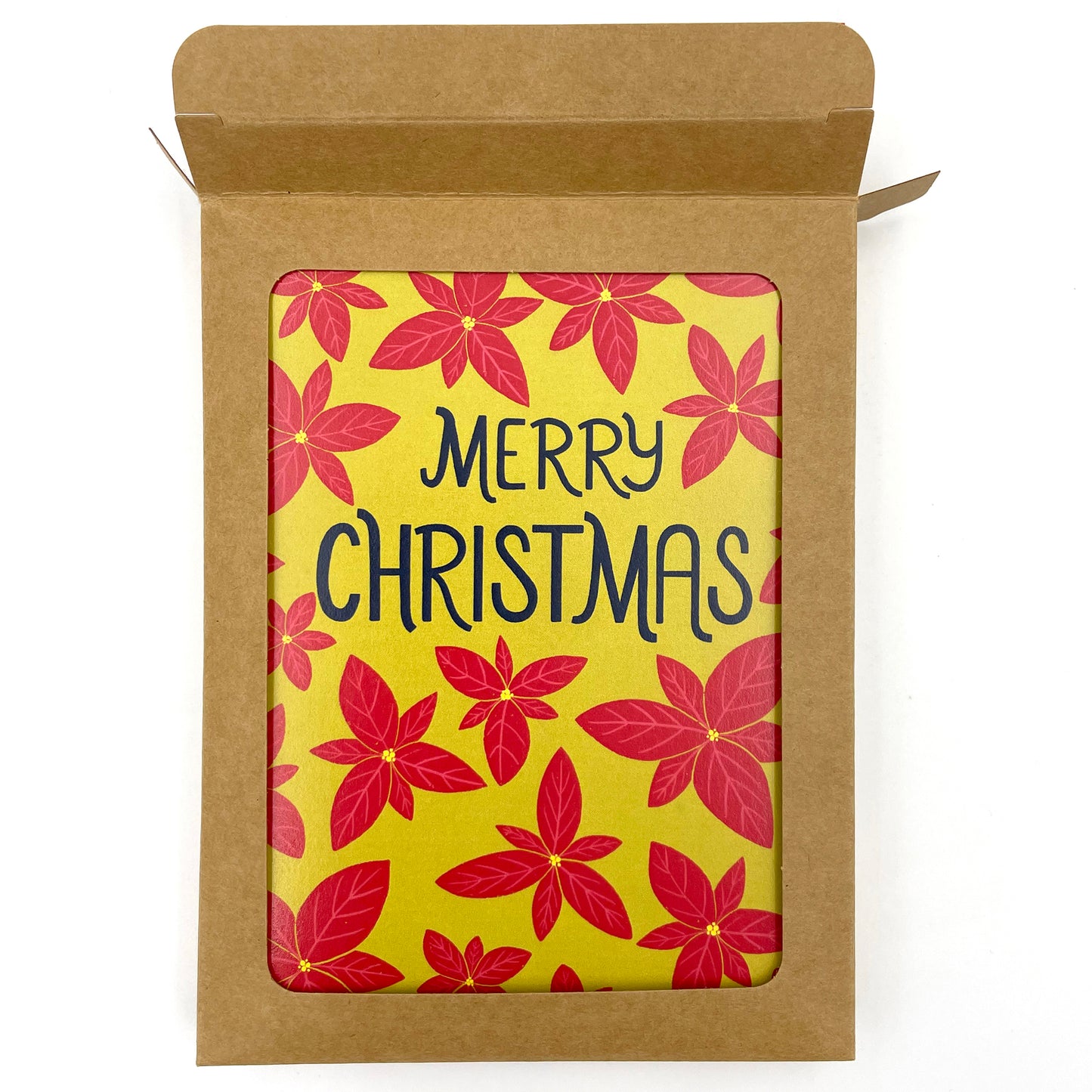 A bright green card features a pattern of bright red poinsettias and the words Merry Christmas in navy in the upper third. The card shows through a window in a kraft paper card box. The top flap of the box is open.