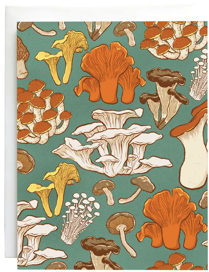 A greeting card patterned with various mushrooms is against a white envelope.