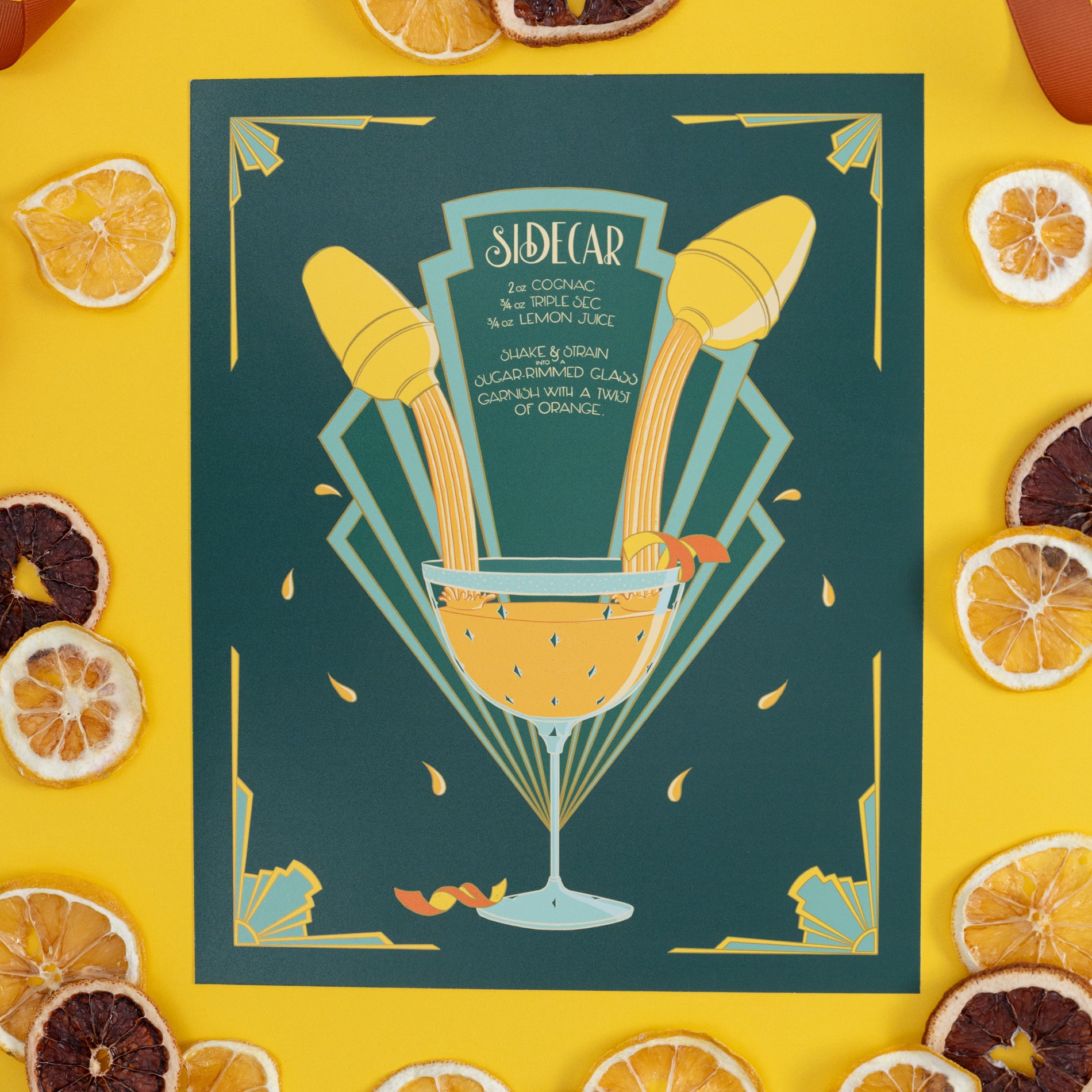 An art deco illustrated recipe for a sidecar is on yellow with citrus slices.